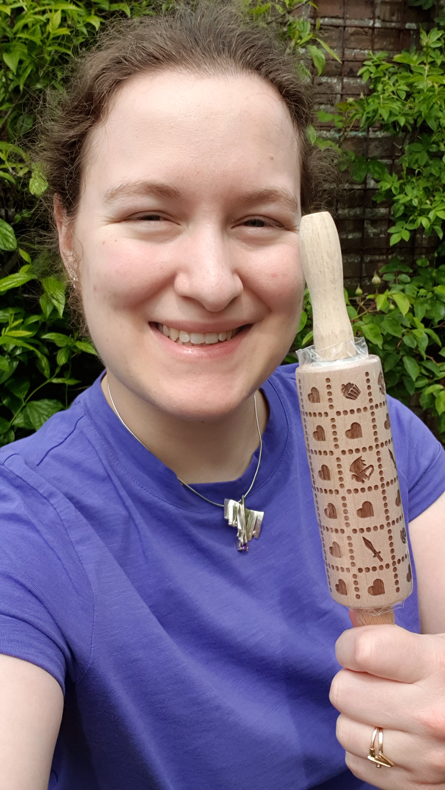Photo of Minerva holding up the rolling pin