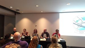 Photo of the 5 panellists of the Flash Fiction panel at a tabel.