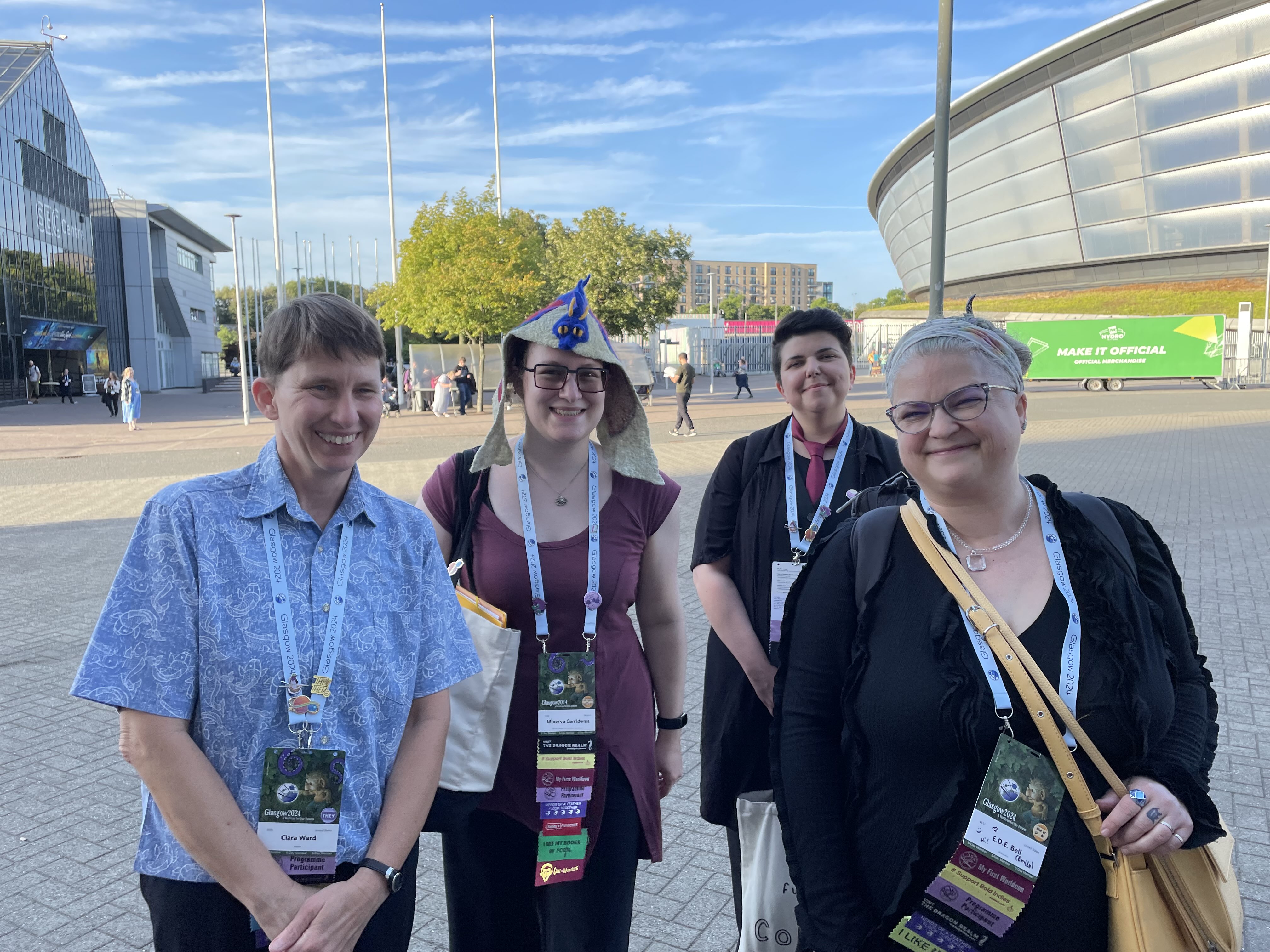 Photo of 4 smiling people with Worlcon badges